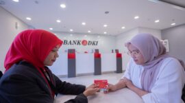 Keterangan Foto : Salah satu pegawai bank DKI sedang menunjukan kartu ATM Bank DKI ke nasabah Bank DKI/Doc/Ist